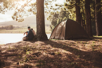 Mature couple camping by a lake
