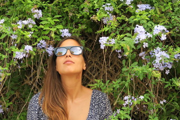 Young girl in front of foliage