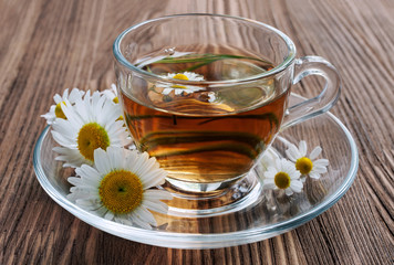 Healthy tea with chamomile in glass cup