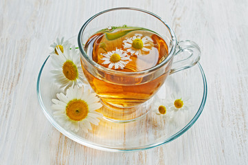 Healthy tea with chamomile in glass cup