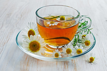 Healthy tea with chamomile in glass cup