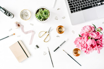 Fototapeta na wymiar Workplace with laptop, succulent, peonies, golden scissors, spool with beige ribbon, pencils and diary. Flat lay composition for bloggers, magazines, social media and artists. Top view.