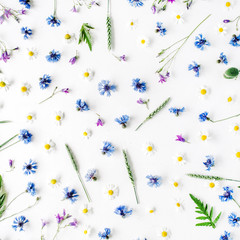 pattern with chamomile flowers, cornflowers and green branches. Flat lay, top view