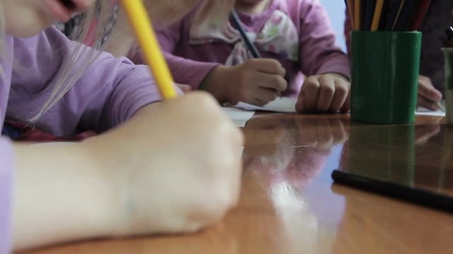 children draw kindergarten pencils and paints on paper