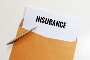 Insurance in envelope with pen on table - business concept