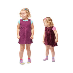 Couple young little girls standing over isolated white background
