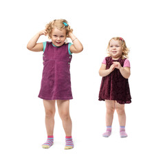 Couple young little girls standing over isolated white background