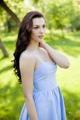 Fototapeta premium Portrait of a beautiful young Caucasian woman in a spring garden.