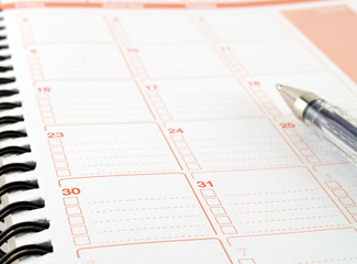 calendar notebook with date and checklist box for daily to-do list and pen