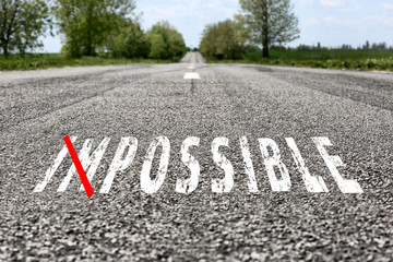 Changing the word impossible to possible on asphalt road