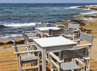 Table and chairs by the sea at Paphos, Cyprus