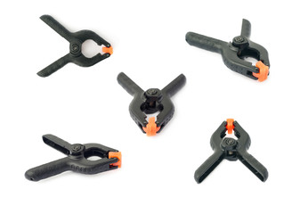 Set of Clamp with orange plastic jaws, isolated over the white background