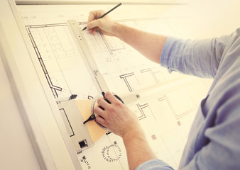 Naklejka na ściany i meble Male architects working on blueprints