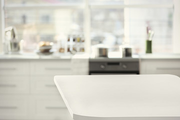 Empty wooden table and blurred kitchen background