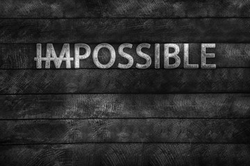Word impossible transformed into possible on grey wall