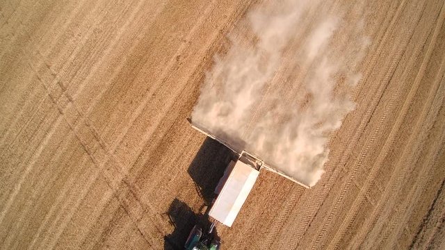 Over the top view of the agriliming truck while putting chemicals on the soil