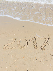 2017 inscription on the sand