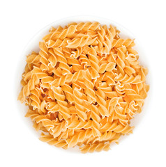 Heap of fusilli in bowl - traditional italian pasta isolated on white background. Design element for bakery product label, catalog print, web use. Top view.