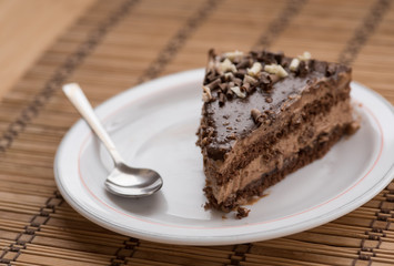 Slice of chocolate cake  garnished with nuts