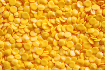 yellow industrial plastic pellets background