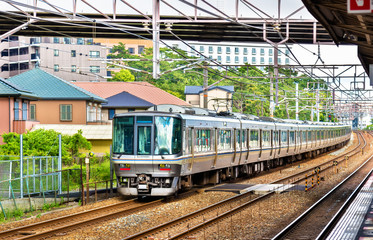Rapid train is passing Maiko station, Japan
