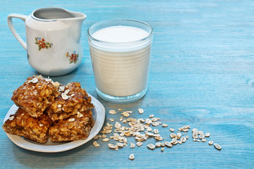 oat snacks, a glass of milk on a blue wooden table
