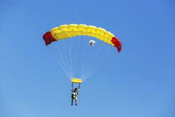 Two Skydiver with yellow parachute on blue sky