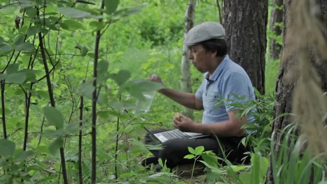 Man communicates via Skype in the forest, using the mobile Internet