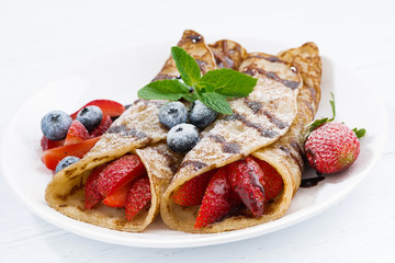 crepes with fresh berries and chocolate sauce