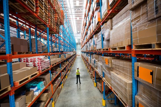 Warehouse manager standing in aisle