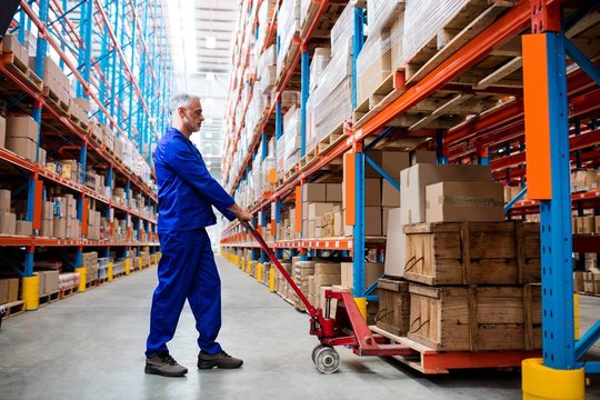 Man worker using pallet truck 