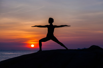 Fototapeta premium Yoga at sunset time