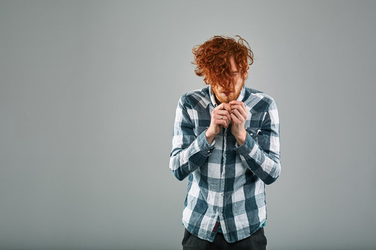Red Hair Models. Bearded man. Portrait. Young emotional man in plaid shirt on gray background - Powered by Adobe