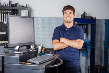 Confident Technician Standing Arms Crossed In Repair Shop
