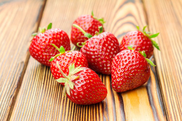 Group of ripe, organic strawberry on wooden table