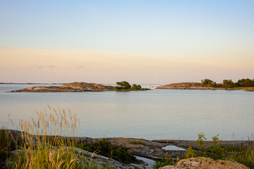 Moored sailboats and skerries in sunset light
