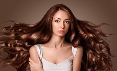 Model with long  brown hair. Waves Curls Hairstyle. Hair Salon.