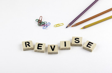 Text: Revise from wooden letterson on white office desk