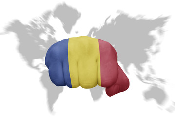 fist with the national flag of romania on a world map background
