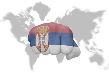 fist with the national flag of serbia on a world map background