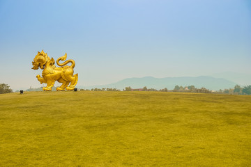 Singha golden statue on blue sky background