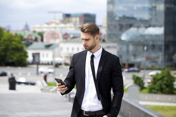 Young successful businessman calling by phone