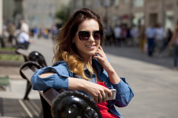 Young brunette woman calling by phone