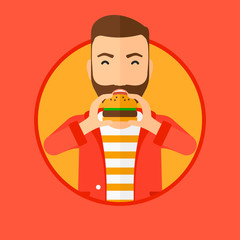 Man eating hamburger.