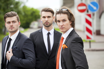 Three young men in elegant business suits