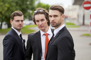 Three young men in elegant business suits