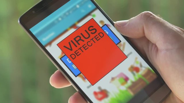 Downloading content on a smartphone when a warning virus message shows up on the screen. Antivirus applications.