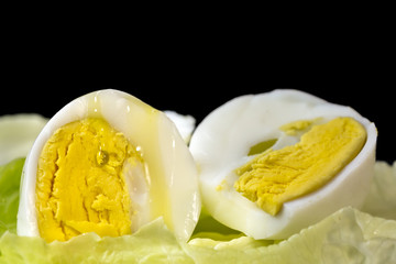 Drop of Extra Virgin olive oil over the yolk of a hard boiled egg cut in half