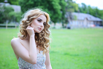 young beautiful curly blonde hair slim girl fashion portrait in white dress posing looking away...