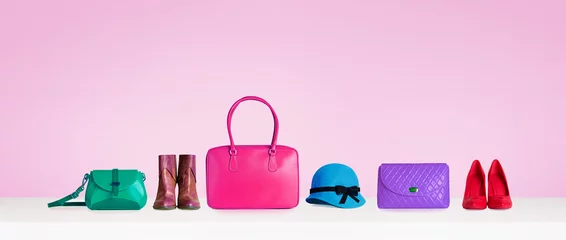 Tapeten Colorful hand bags,purse,shoes, and hat isolated on pink background. Woman fashion accessories items. Shopping image.  © MoustacheGirl